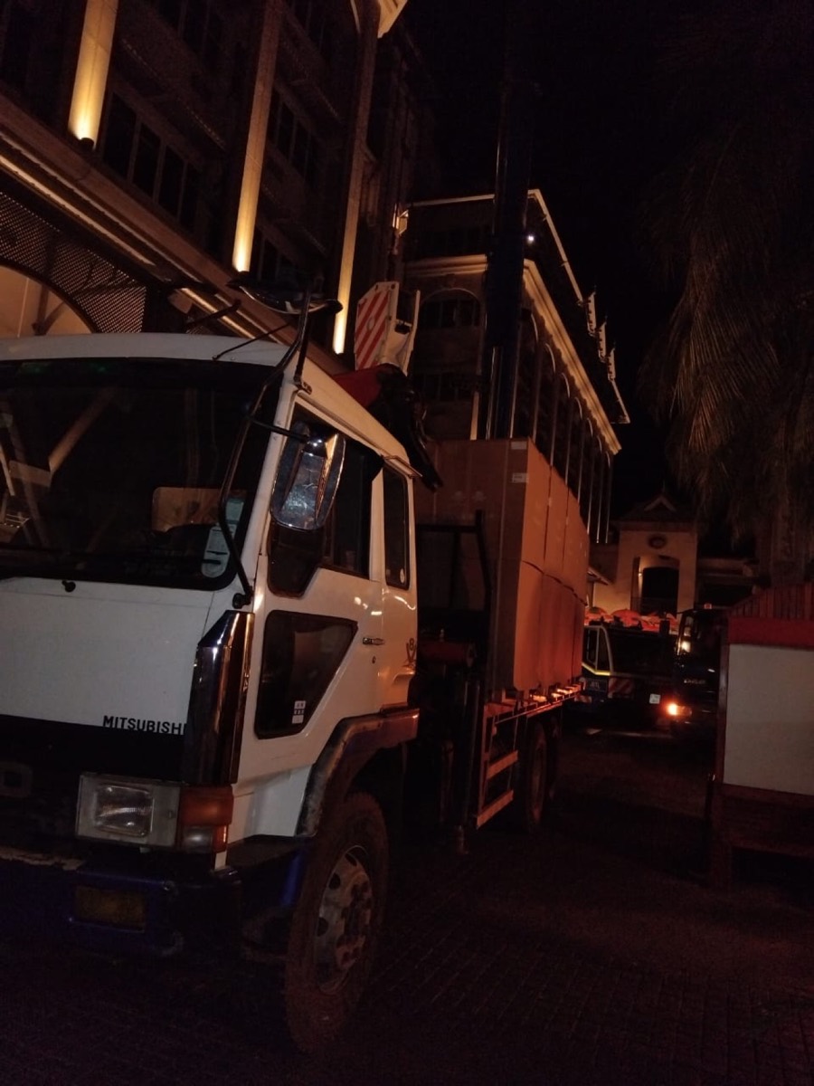 JSTL crane lifting a load at night