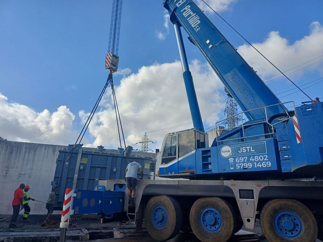 JSTL crane lifting a power transformer at a substation