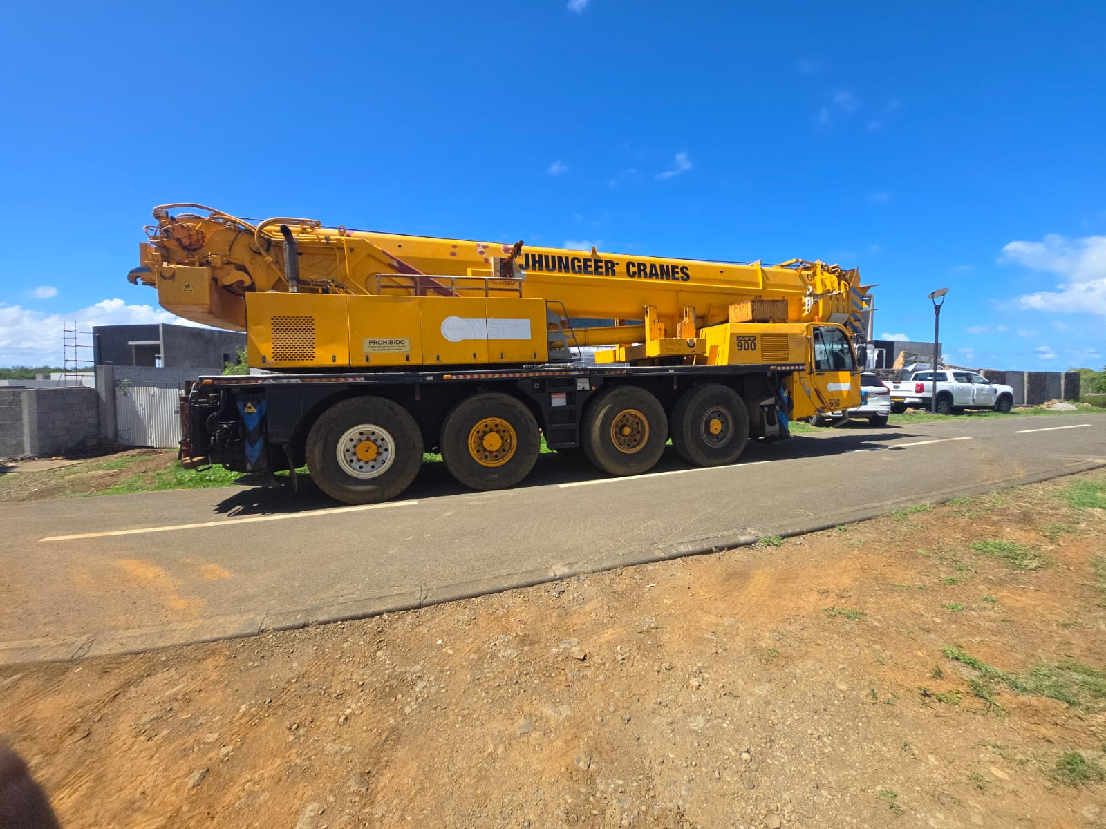 Yellow AT-900 all-terrain crane parked on site
