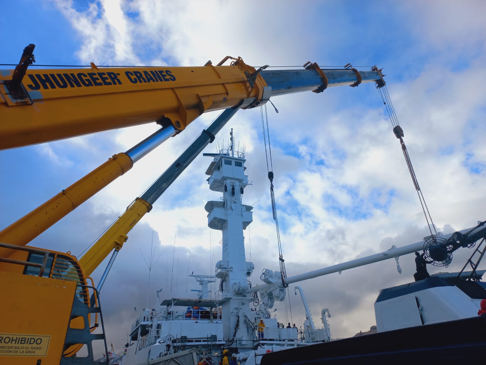 Crane boom over a ship at the quayside